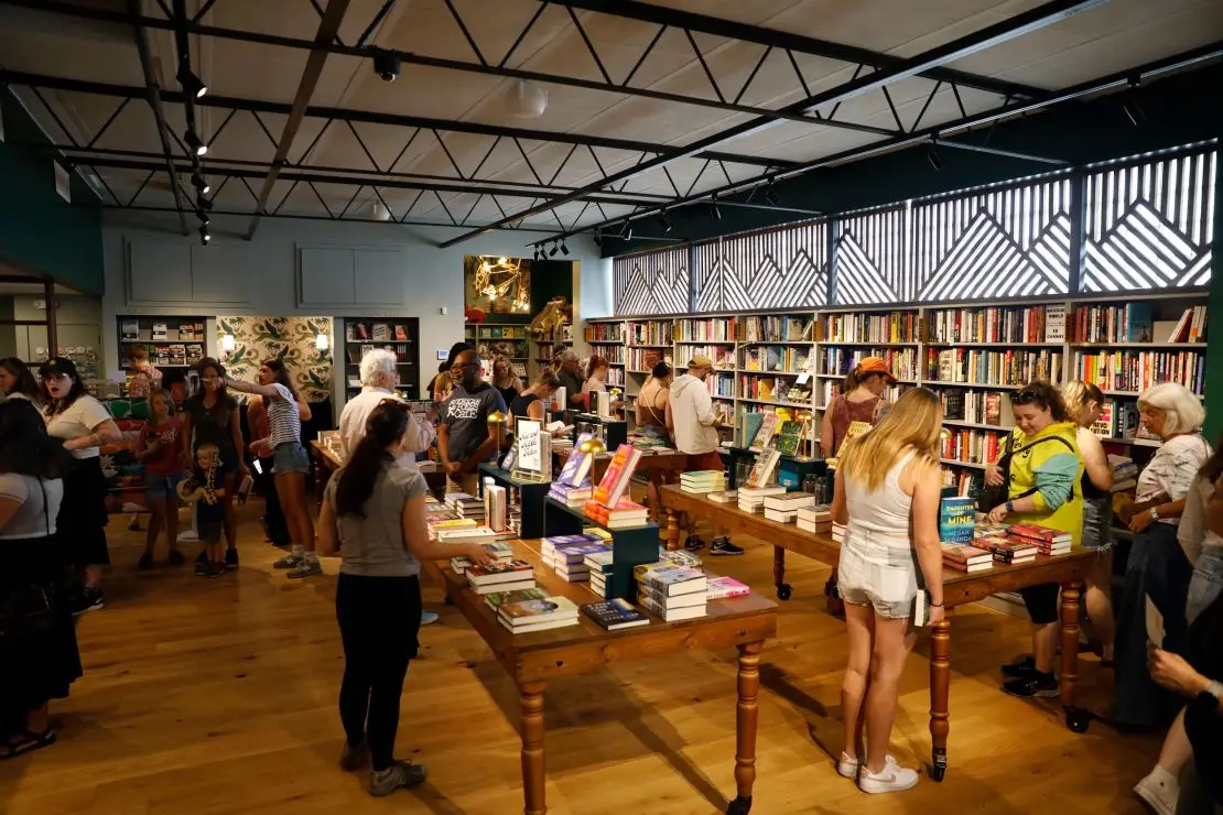 Customers browse for books during the grand opening of The Lynx. From the first few minutes of its opening, the store reached capacity, and a growing line waited out back to be let in.