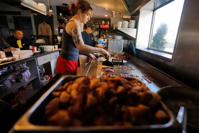 Audrey Garrison prepares an omelet at the Little Phoenix Restaurant on Acushnet Avenue in New Bedford.