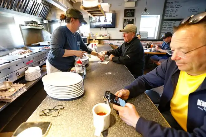 Kathy DeTerra tends the popular counter which faces the cooking area inside of the Little Phoenix Restaurant on Acushnet Avenue in New Bedford.