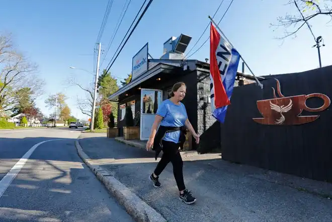 A woman walks past the newly renovated facade of the Little Phoenix Restaurant on Acushnet Avenue in New Bedford.