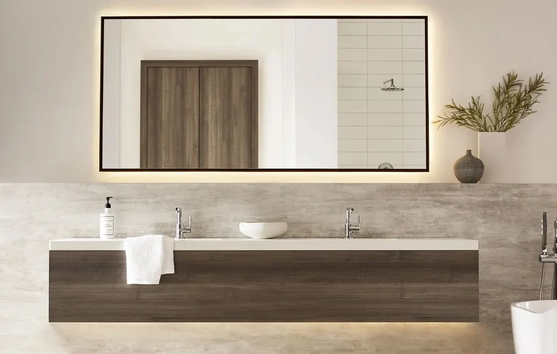 A bathroom sink with wood accents and a mirror above