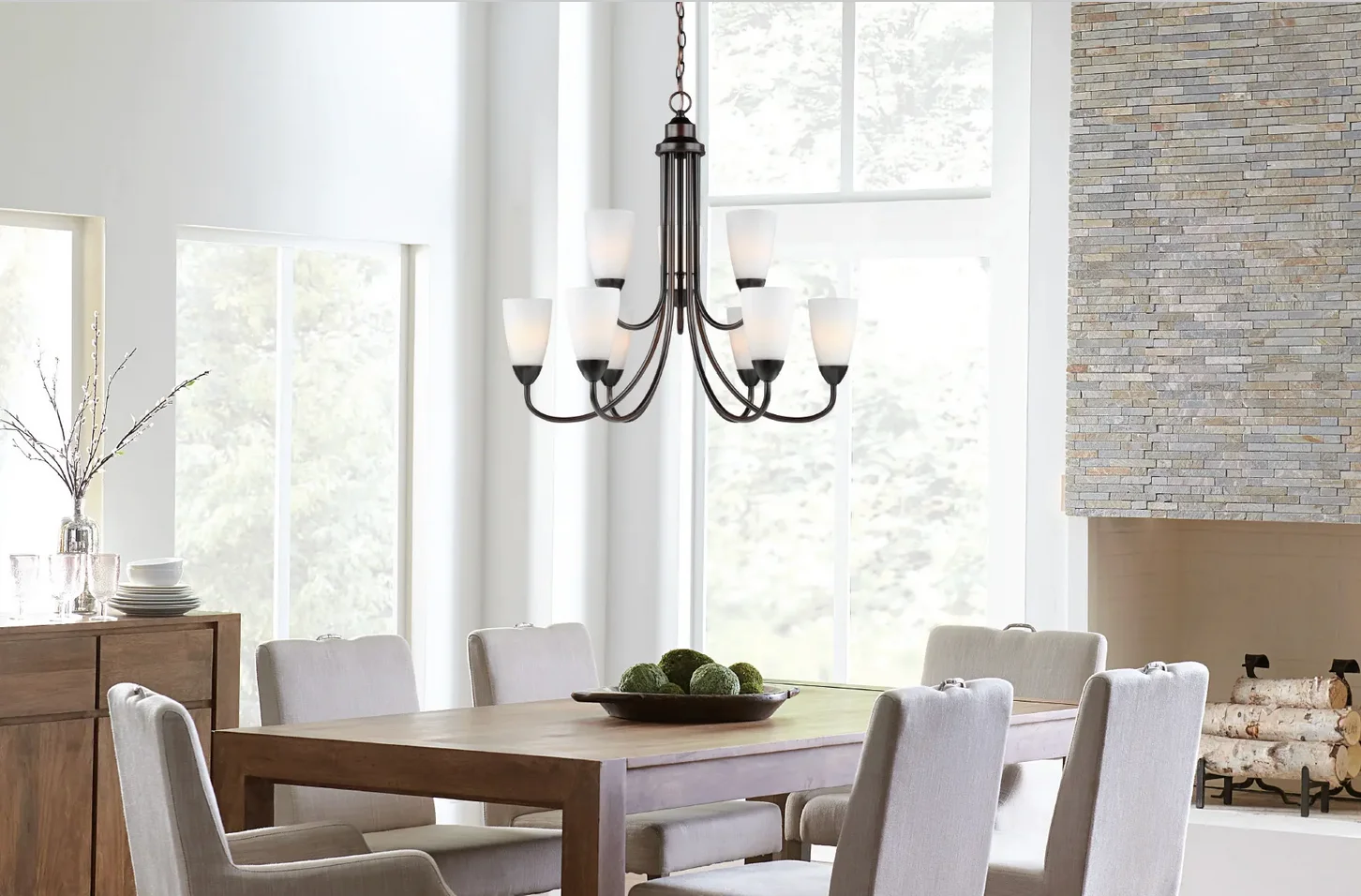 A black chandelier over a small dining table