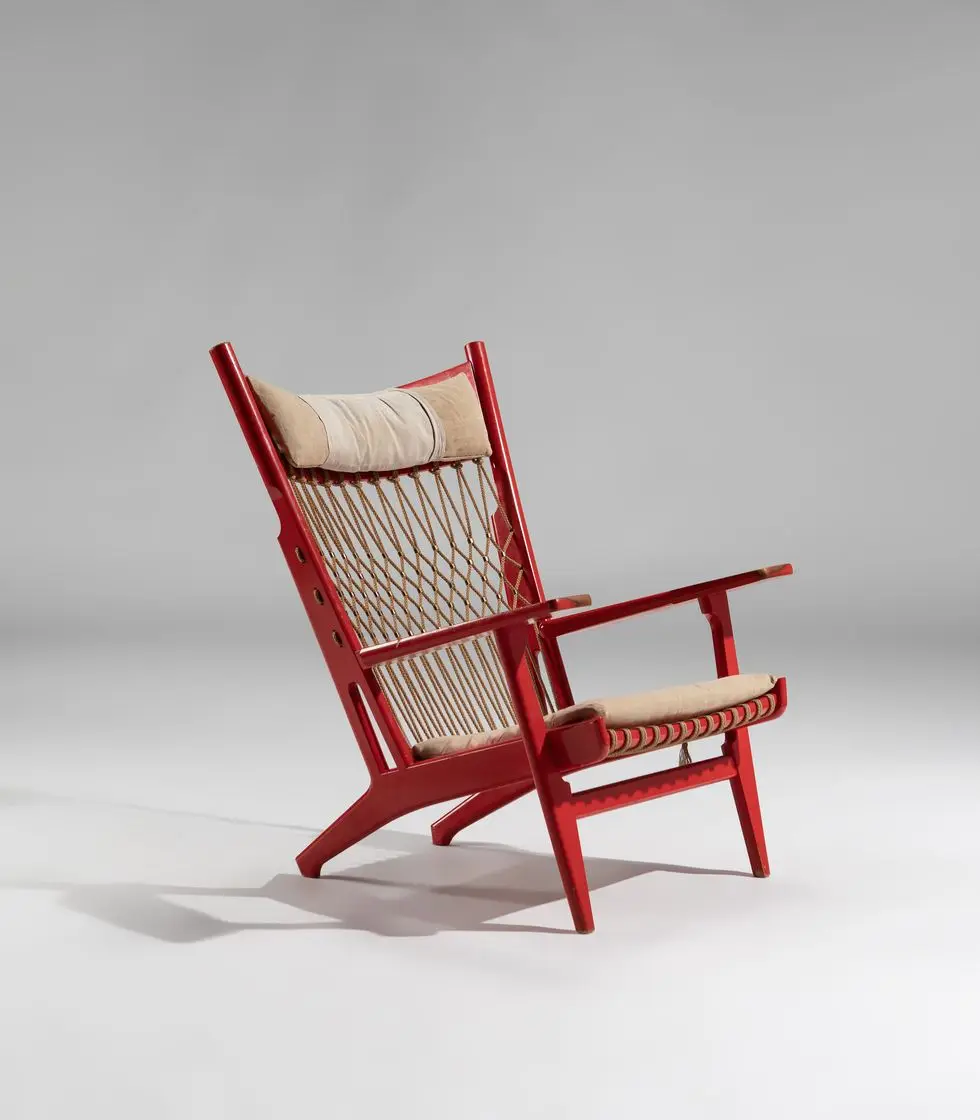 a red chair with a white pillow