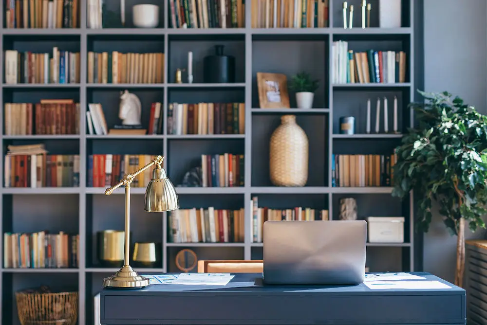 Table with laptop in home office interior