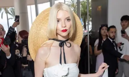 Anya Taylor-Joy at the Hôtel Martinez in a Jacquemus straw hat.
