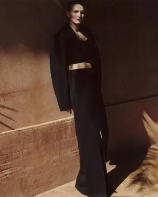 Model wears black against backdrop of Moroccan hotel