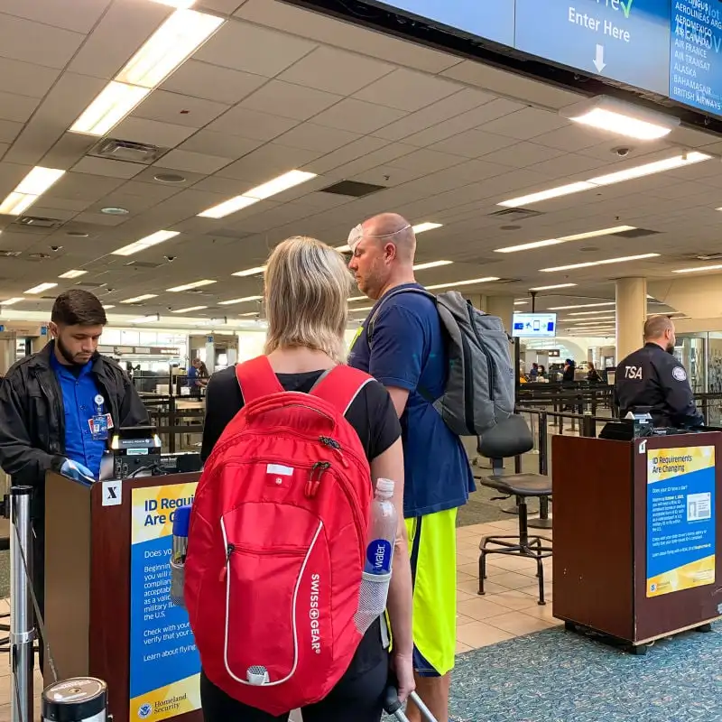 Travelers speaking with TSA agent