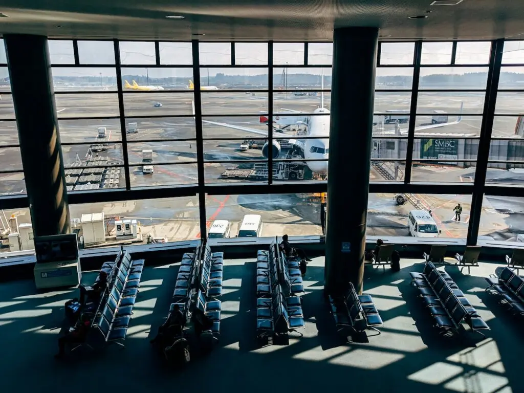 A view of an airport terminal interior with air travellers.