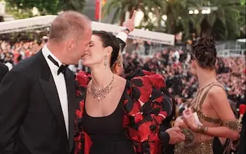 Bruce Willis and Demi Moore kiss at the top of the steps of the Palais des festivals at The Fifth Element premiere