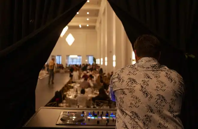 The DJ mixes music at the 2024 Fashion Week of Rochester on May 17, 2024.