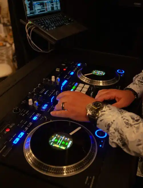 The DJ mixes music at the 2024 Fashion Week of Rochester on May 17, 2024.