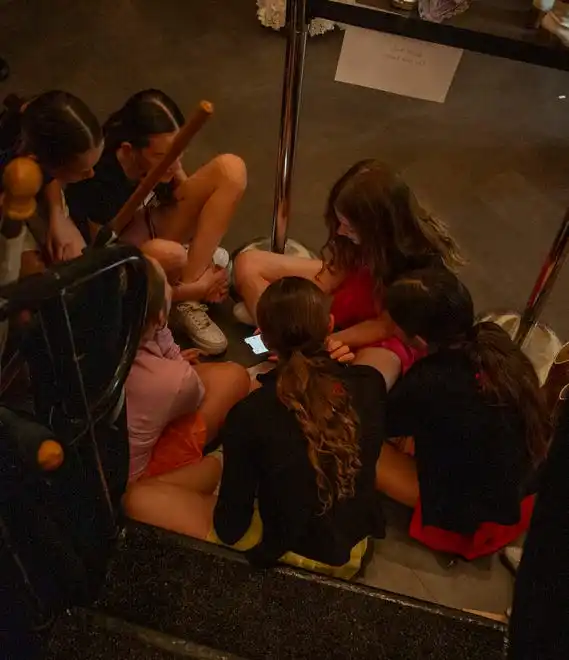 A group of girls hang out backstage before the 2024 Fashion Week of Rochester begins on May 17, 2024.