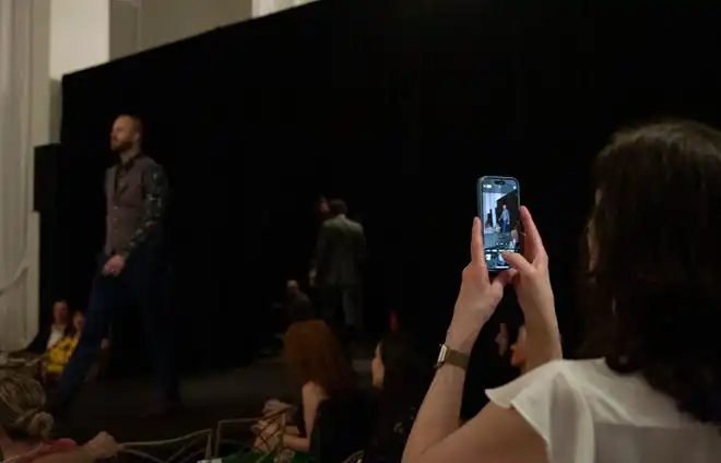 Janet Mears takes a photo of a her son, Liam Mears, walking down the runway at the 2024 Spring Fashion Week of Rochester on May 17, 2024.