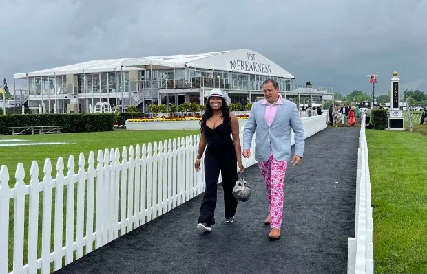 Valerie Marks of Lutherville and Joe Medrano of Potomac arrive at Pimlico Race Course on Preakness Day 2024. (Barbara Haddock Taylor/Staff)