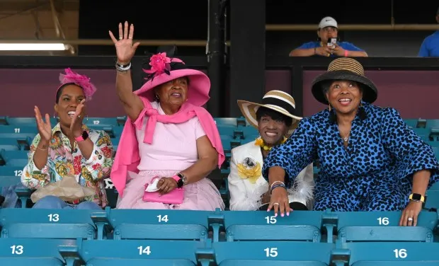 Sherre Harris, left, with her mother, Carolyn Smith, aunt, Bernadine McIver and family friend Marion Murphy all cheer for the horses they bet on in the 7th race at Pimlico Race Course. (Lloyd Fox/Staff)