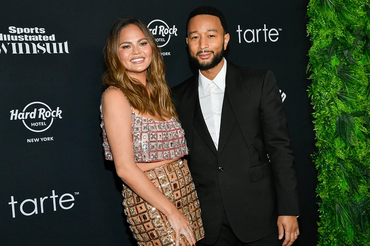 Did Chrissy Teigen and John Legend kick a person out of a photobooth to take a picture themselves? Here’s what happened