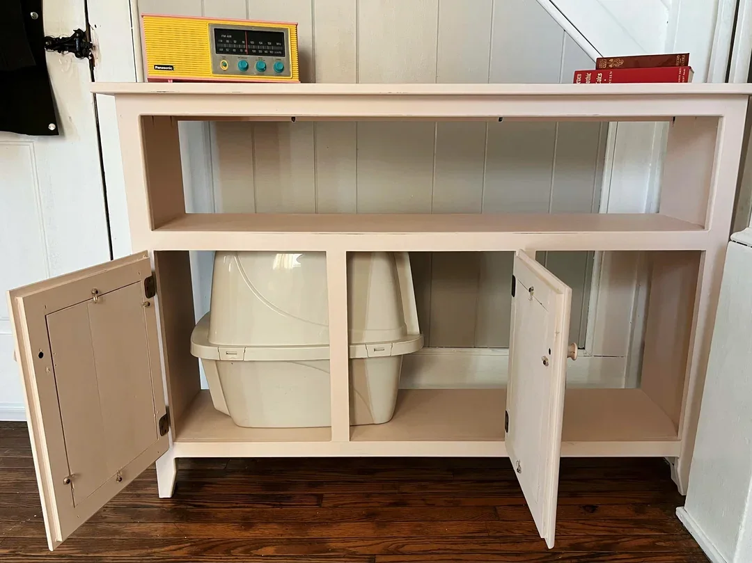 The litterbox is perfectly concealed within the TV stand