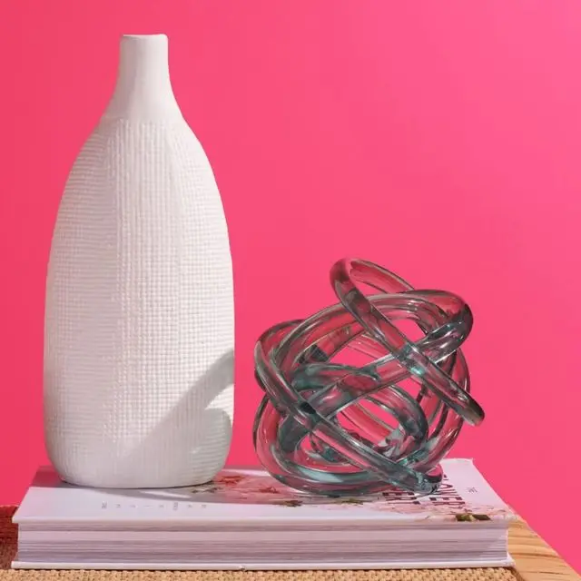 Vase and decorative ball on book