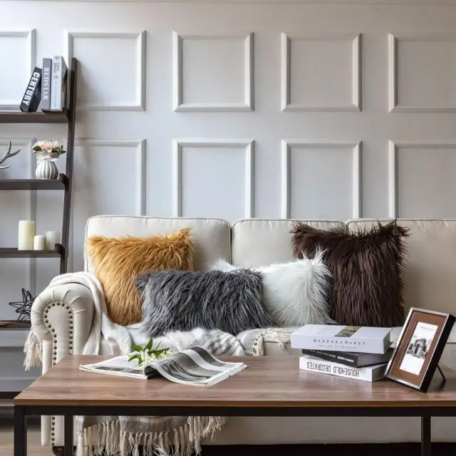 living room with furry textured throw pillows displayed on couch