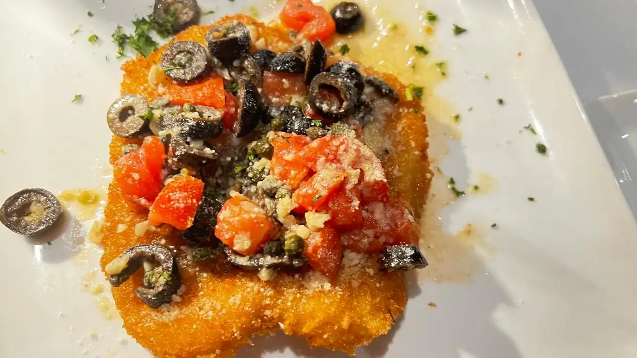 At The Nest in Jensen Beach, the calamari steak was pounded flat, breaded and pan fried then topped with briny black olives, chopped tomatoes Mediterranean salsa and a squeeze of lemon.