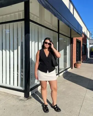 @marina_torres wearing a waistcoat and skirt