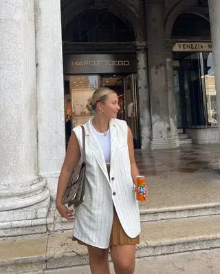 @oliviamarcus wearing a waistcoat and skirt