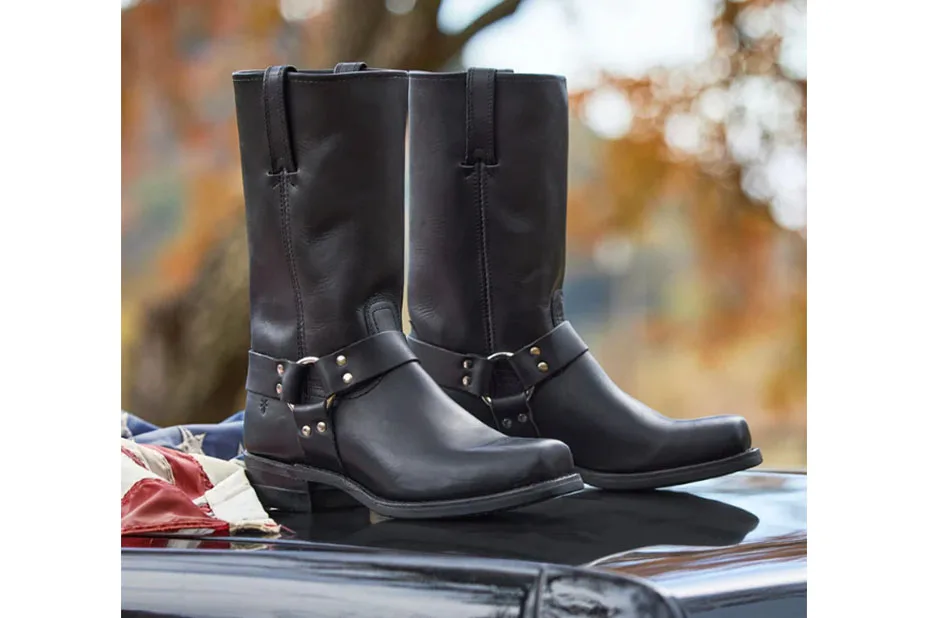 Pair of black boots on a car hood