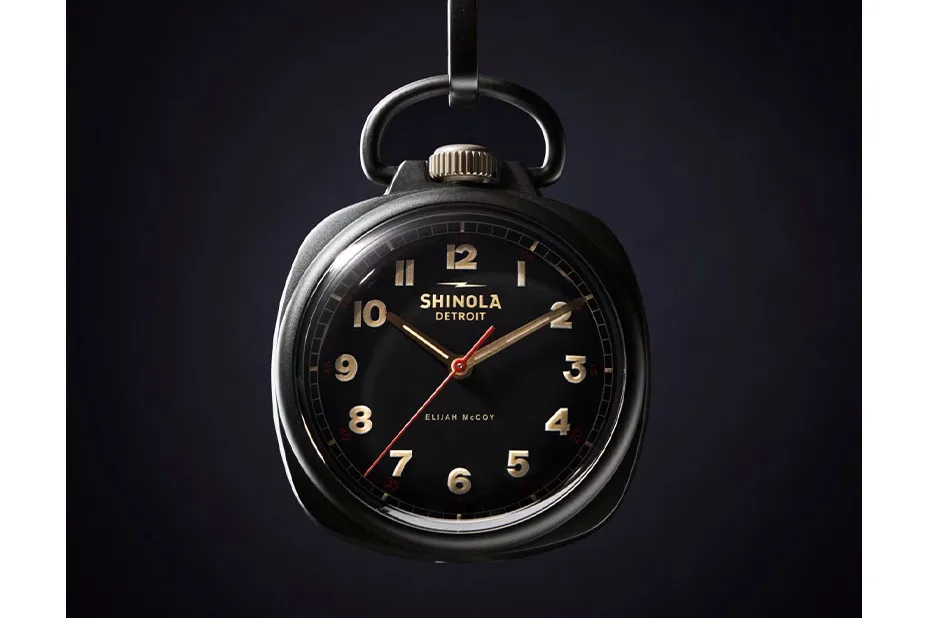 A black pocket watch with white text