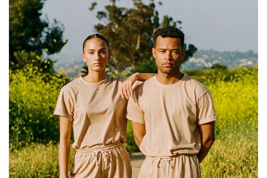 A man and woman standing in a field