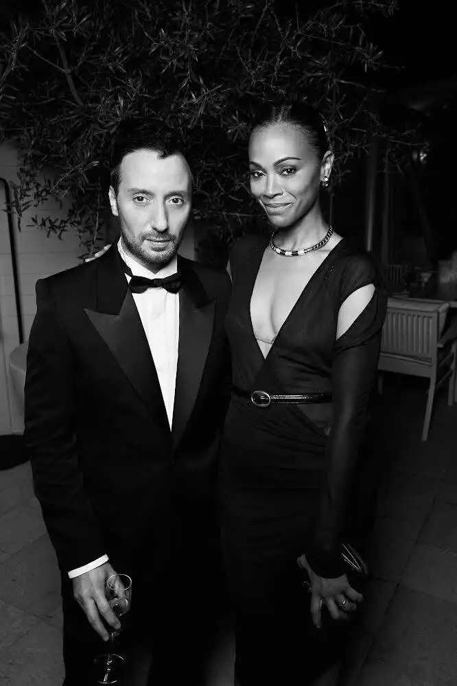 Image may contain Anthony Vaccarello Zoe Saldana Clothing Formal Wear Suit Tuxedo Face Head Person and Photography