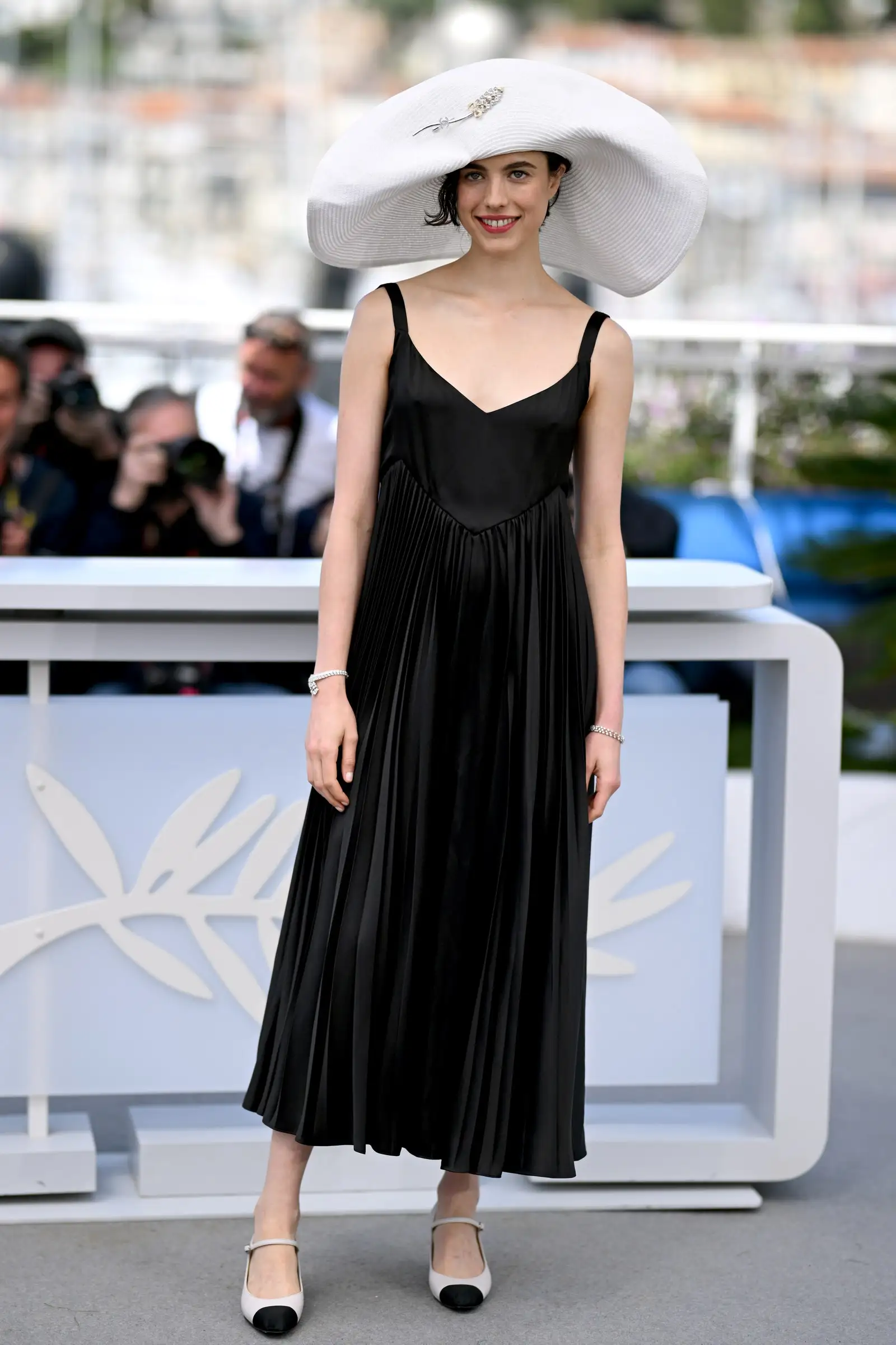 Image may contain Margaret Qualley Person Clothing Dress Adult Accessories Bracelet Jewelry Hat and Glasses