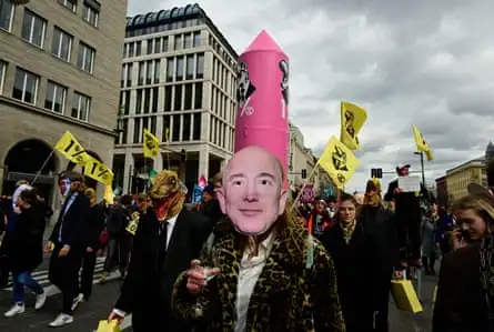 Climate activists of Extinction Rebellion wearing masks of company CEOs including Amazon’s Jeff Bezos take part in a demonstration in Berlin