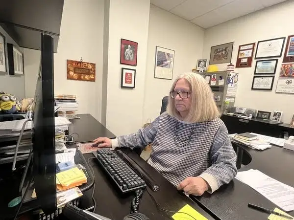 a woman works on her desk