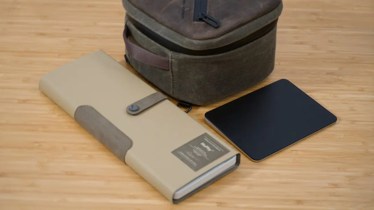 Keyboard in a case and Magic Trackpad next to the Shield Case