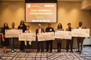 The winners celebrate at Resorts World New York City on May 8. Michelle Stoddart from Resorts World, Deputy Borough President Ebony Young, QEDC Executive Di­rector Seth Bornstein, and David Tanis from Patrick B. Jenkins & Associates are also in the group.