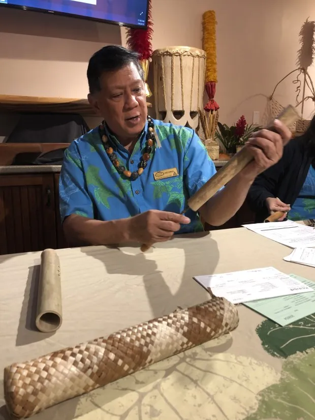 A staff member with the Outrigger Ka'anapali Beach Resort's cultural center demonstrates how to make a nose flute in a workshop. (Photo by Ben Davidson Photography)