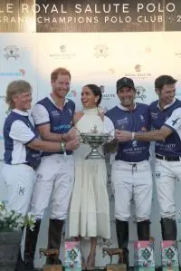 The Duchess of Sussex presents the trophy to her husband, the Duke of Sussex after his team the Royal Salute Sentebale Team defeated the Grand Champions Team, in the Royal Salute Polo Challenge, to benefit Sentebale, at The USPA National Polo Center in Wellington, Florida, US. Picture date: Friday April 12, 2024. (Photo by Yaroslav Sabitov/PA Images via Getty Images)