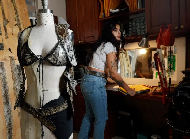 Designer Elle Barbeito works in her Miami studio, Thursday, May 16, 2024 She uses python skins in her latest collection,. Florida Girl, which is inspired by women she knows. (Joe Cavaretta/South Florida Sun Sentinel)