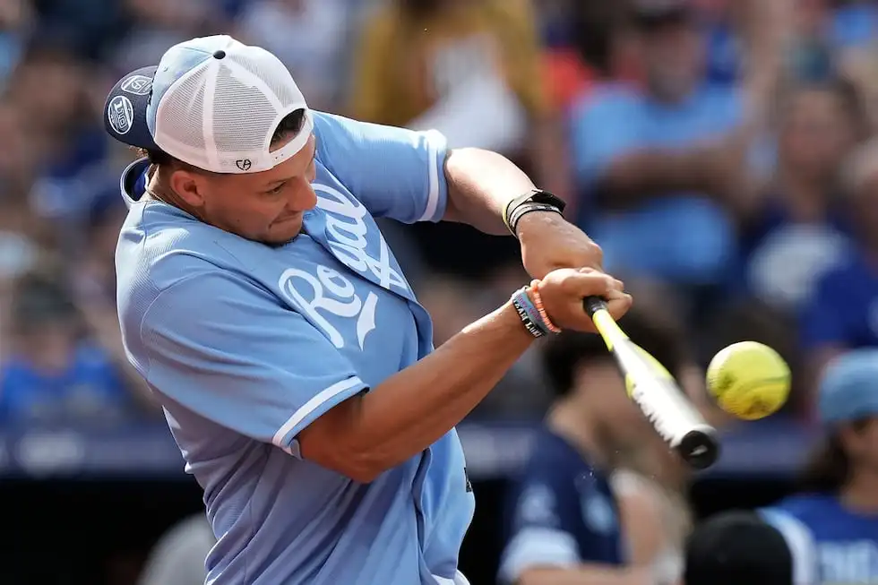 Kansas City Chiefs quarterback Patrick Mahomes bats during a softball game at Kauffman Stadium...