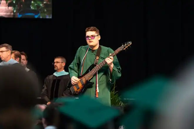 York Tech senior, Cole Saylor, plays the National Anthem with the bass guitar during the commencement ceremony at UPMC Arena on Thursday, May 23, 2024.