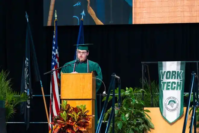 York Tech senior Ian Morris delivers a speech to his class about perceptions, acceptance, and breaking the status quo during the commencement ceremony at UPMC Arena on Thursday, May 23, 2024.