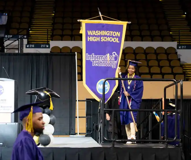 Washington High School of Information Technology valedictorian Jessica Brown leads the class of 2024 as flag bearer during the graduation ceremony on Thursday May 23, 2024 at the UWM Panther Arena in Milwaukee, Wis.
