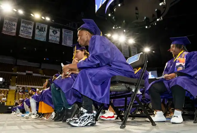Washington High School of Information Technology student (center) Jilani Nefertiti waits to walk the stage during the graduation ceremony on Thursday May 23, 2024 at the UWM Panther Arena in Milwaukee, Wis.