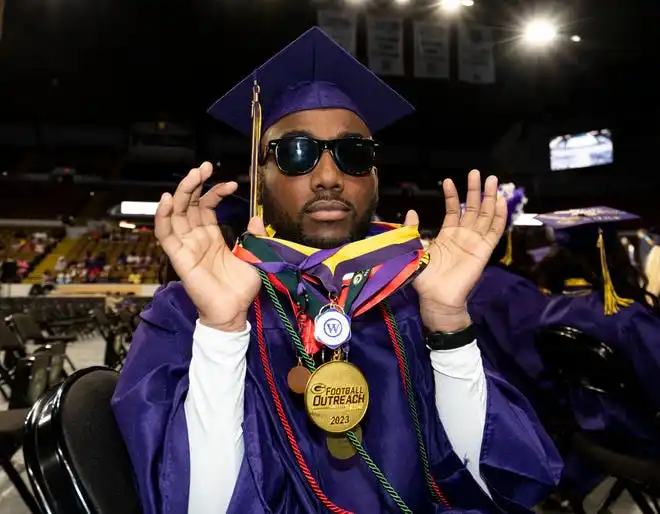 Washington High School of Information Technology student Daniel Martin showcases his student awards during the graduation ceremony on Thursday May 23, 2024 at the UWM Panther Arena in Milwaukee, Wis.