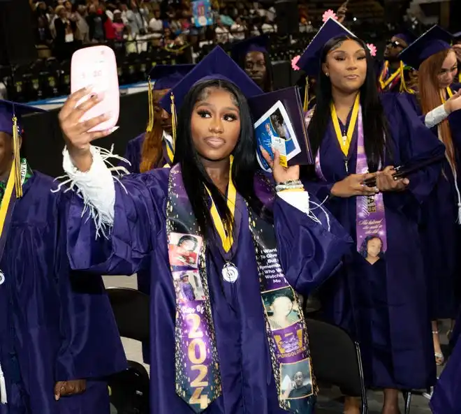 Washington High School of Information Technology student Tiyanna Armstrong takes a selfie after receiving her diploma during the graduation ceremony on Thursday May 23, 2024 at the UWM Panther Arena in Milwaukee, Wis.