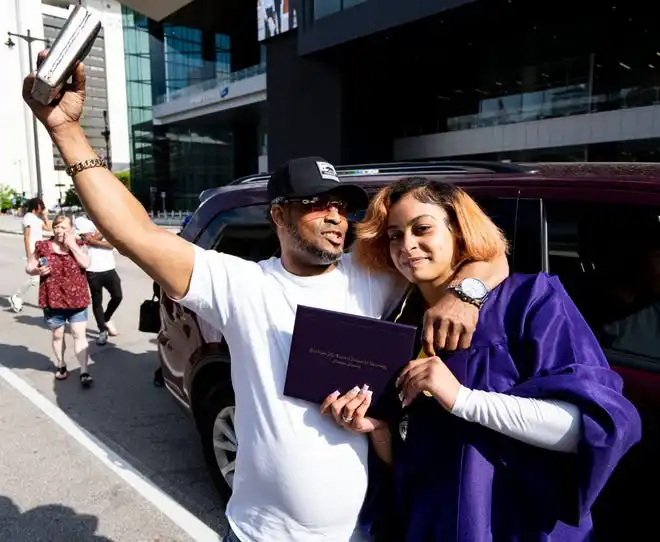Washington High School of Information Technology graduate Kiara Valera is embraced by her father Robert Valera after the graduation ceremony on Thursday May 23, 2024 at the UWM Panther Arena in Milwaukee, Wis.