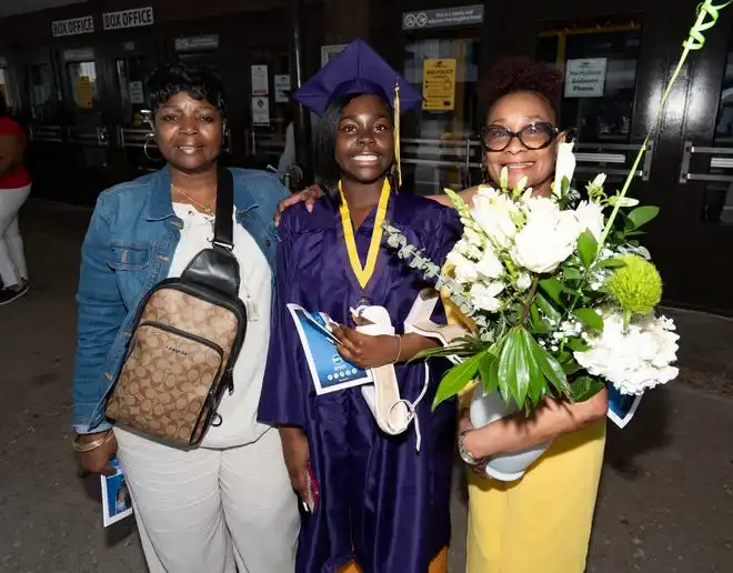 Washington High School of Information Technology graduate Emerald Patterson smiles for a photo with grandparents (left) Juanita Peters and (right) Gloria Green-Williams after the graduation ceremony on Thursday May 23, 2024 at the UWM Panther Arena in Milwaukee, Wis.
