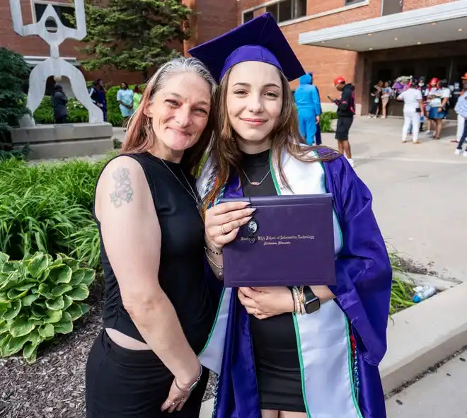Washington High School of Information Technology graduate Jada Reyes, who was also the 2024 class salutatorian, smiles for a photo with parent Katie Reyes after the graduation ceremony on Thursday May 23, 2024 at the UWM Panther Arena in Milwaukee, Wis.