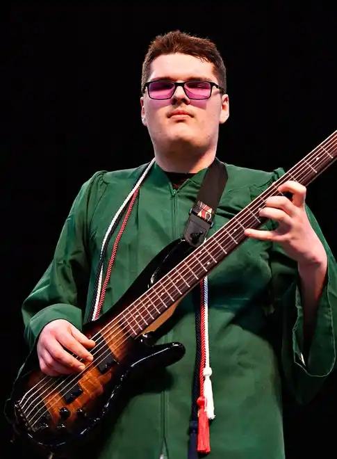 The National Anthem is performed by graduates Cole Saylor, on bass guitar, and Clara Kisielnicki (vocals, not shown) during the York County School of Technology Graduation Ceremony at York Expo Center in West Manchester Township, Thursday, May 23, 2024. (Dawn J. Sagert/The York Dispatch)