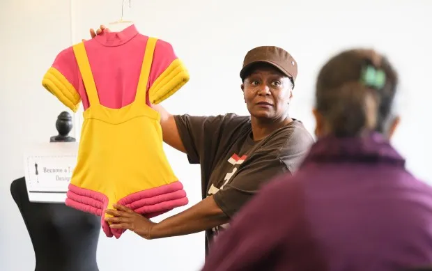 Tammy Pruitt shows a piece of clothing during a fashion designer class in the summer of 2023 at Moraine Valley Community College in Palos Hills. The college will offer four sewing and fashion summer camp classes in June and July. (Glenn Carpenter)